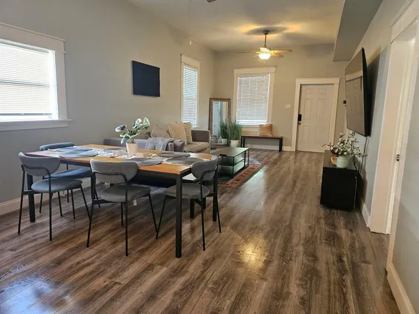 a view of a dining room with furniture and wooden floor