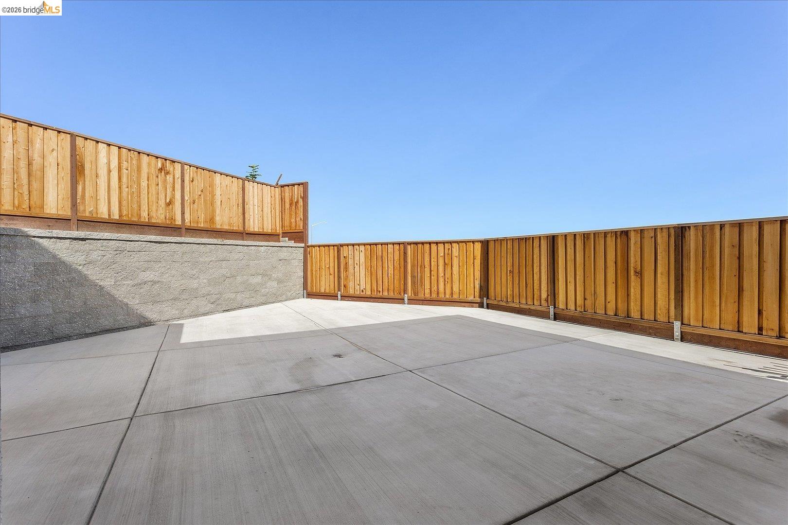 5601 Ridgepoint Way Antioch, CA 94531 - Photo 42 of 59 Expansive concrete patio area featuring a retaining wall and wood privacy fencing