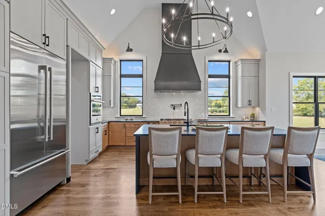 a living room with fireplace furniture and a large window