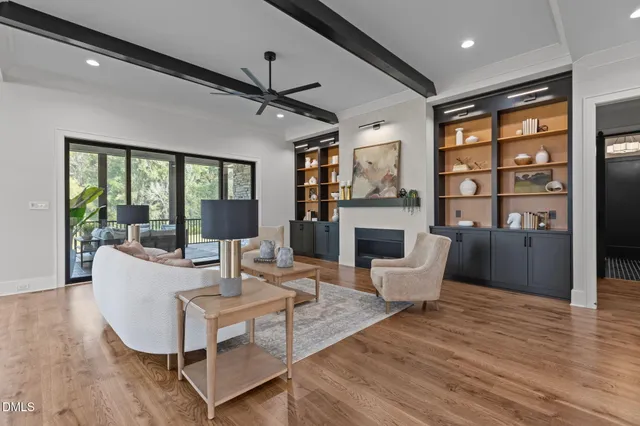 a bedroom with a bed a chandelier and a large window
