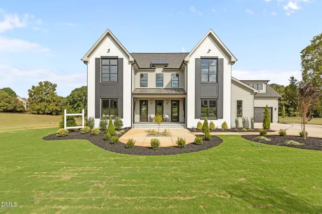 a front view of a house with a yard table and chairs
