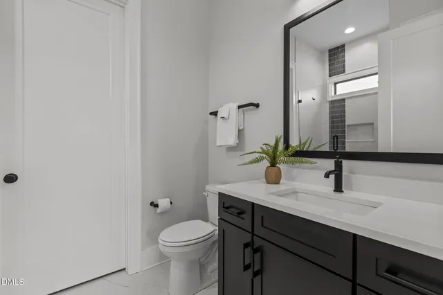 a kitchen with appliances cabinets and a potted plant
