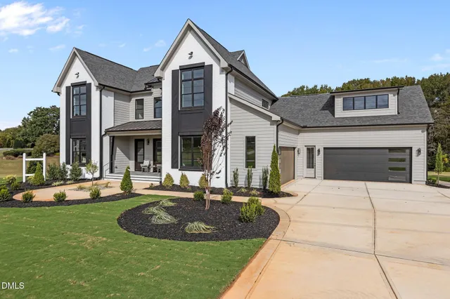 a front view of a house with a yard fire pit and outdoor seating