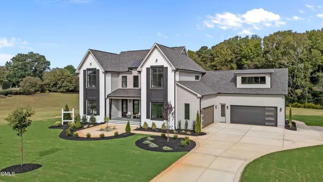 front view of a brick house with potted plants