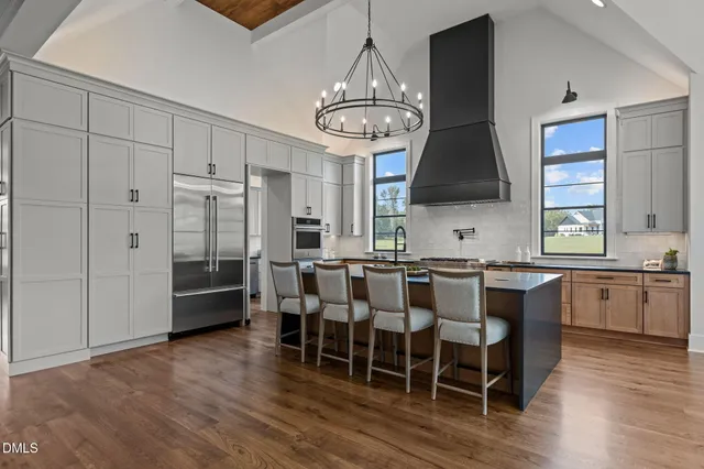 a kitchen with cabinets appliances a sink and a window