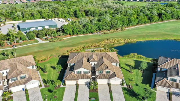 an aerial view of a house with a yard
