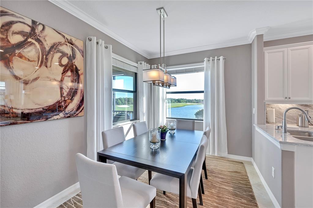 5815 Wake Forest Run, Unit 103 Lakewood Ranch, FL 34211 - Photo 13 of 63 a view of a dining room with furniture window and outside view