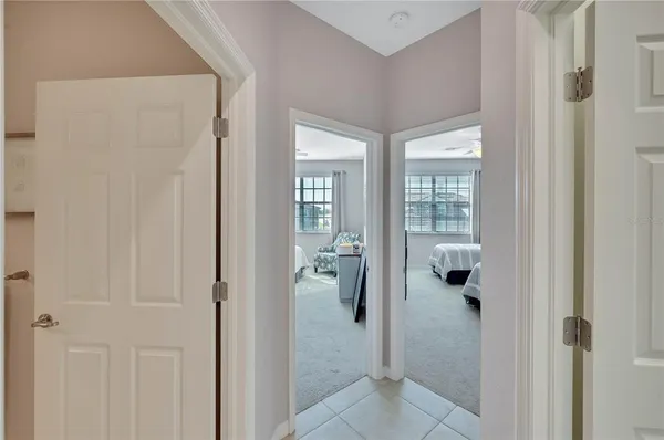 a bathroom with a granite countertop double vanity sink a large mirror a bathtub and vanity
