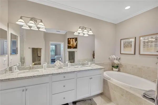 a bedroom with two beds and a chandelier