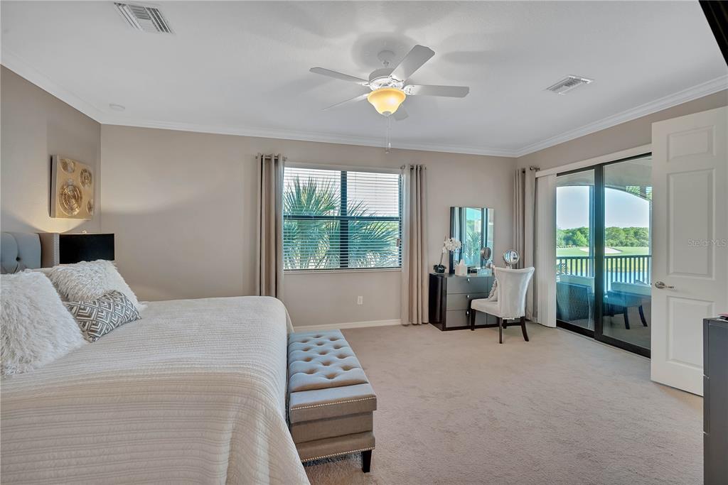 5815 Wake Forest Run, Unit 103 Lakewood Ranch, FL 34211 - Photo 26 of 63 a bedroom with a bed and a couch