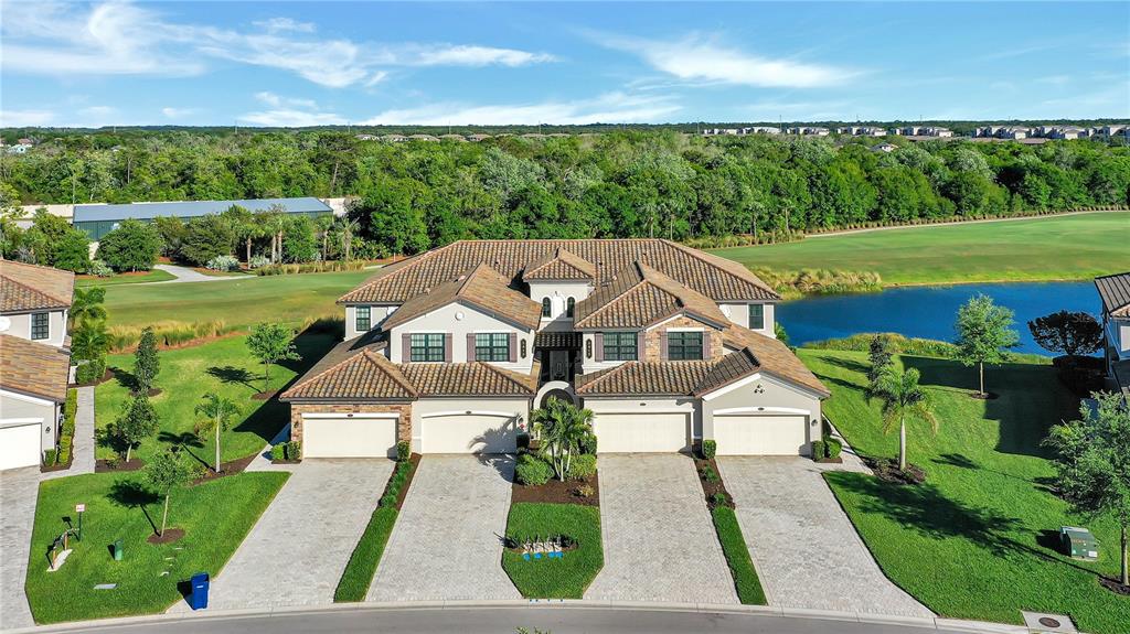 5815 Wake Forest Run, Unit 103 Lakewood Ranch, FL 34211 - Photo 32 of 63 an aerial view of a house with a big yard
