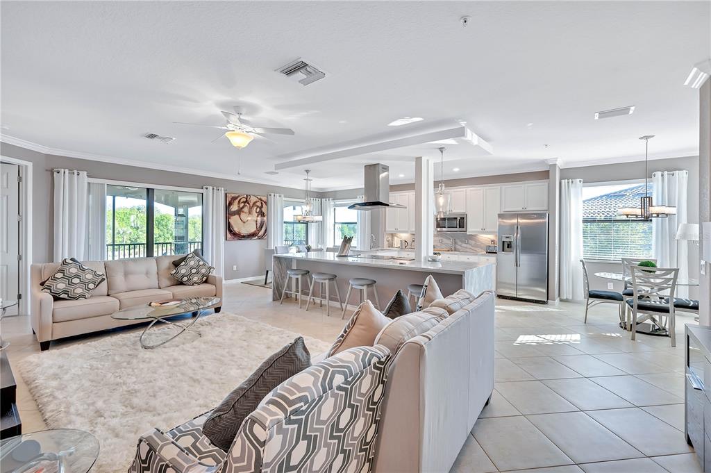 5815 Wake Forest Run, Unit 103 Lakewood Ranch, FL 34211 - Photo 5 of 63 a living room with furniture and a large window
