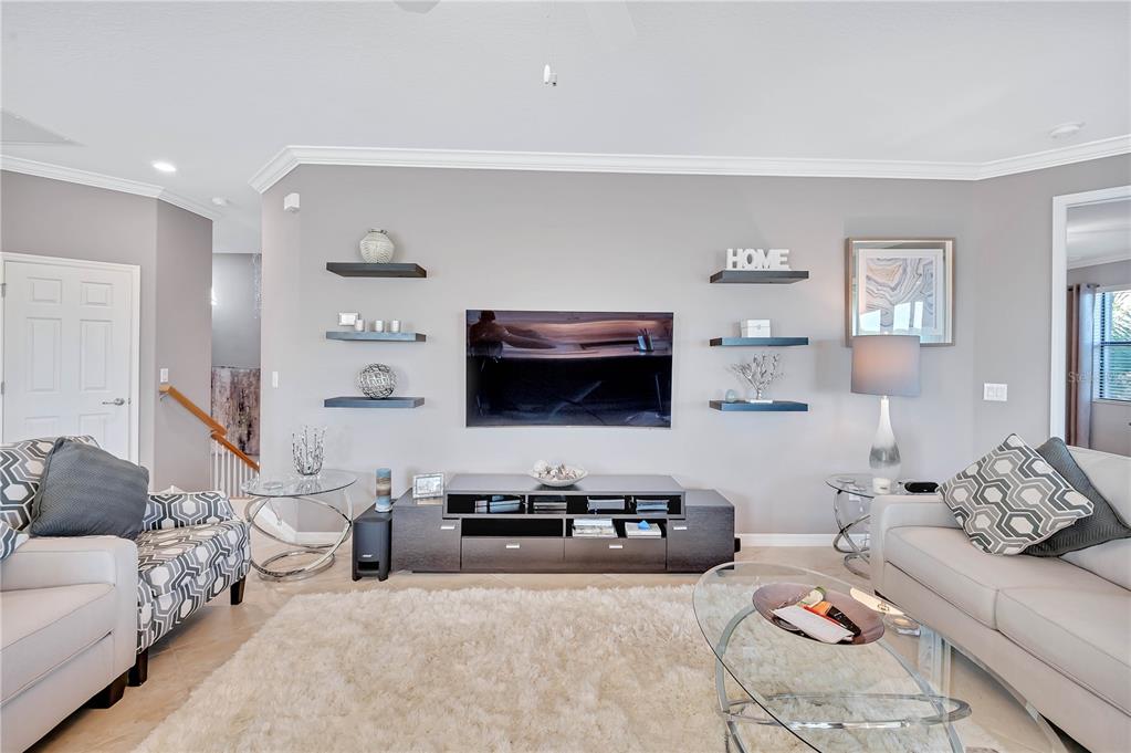 5815 Wake Forest Run, Unit 103 Lakewood Ranch, FL 34211 - Photo 6 of 63 a living room with furniture and a flat screen tv