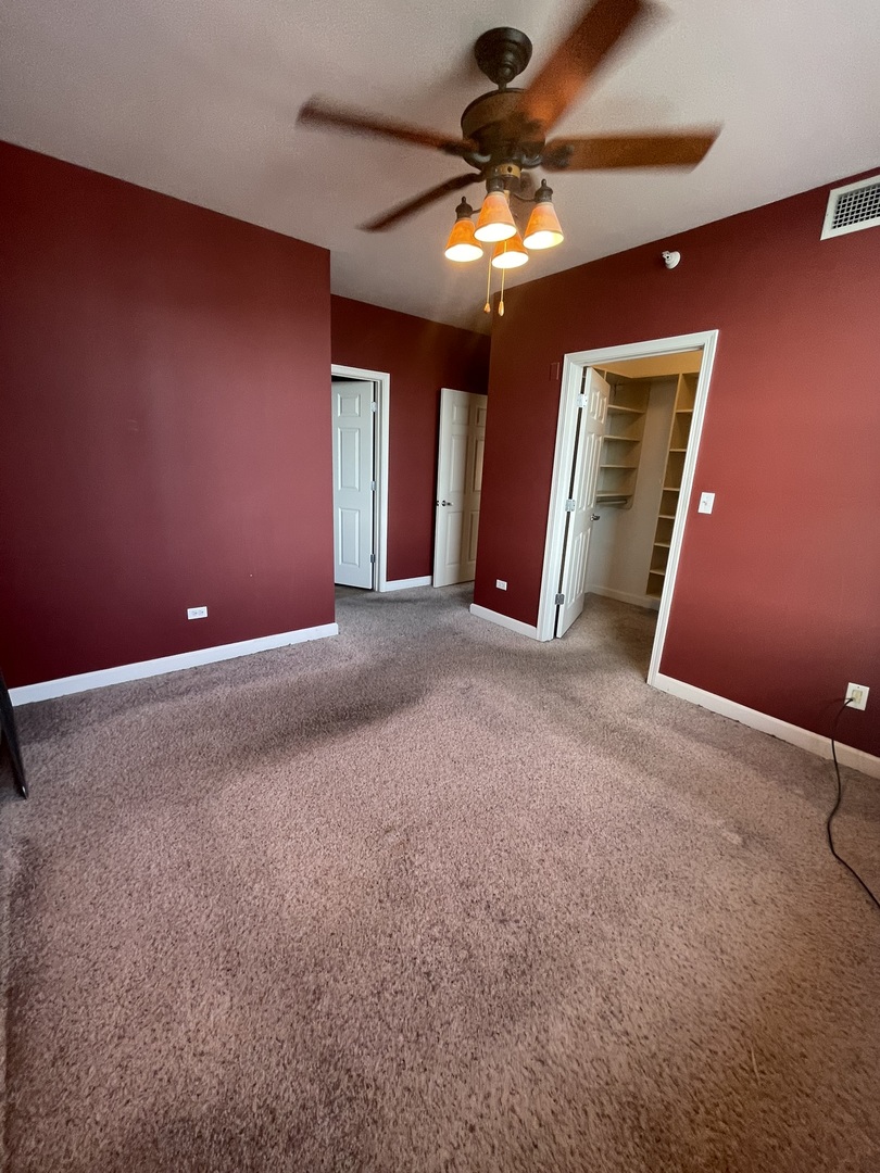 1101 South State Street, Unit 2104 Chicago, IL 60605 - Photo 16 of 37 a view of an empty room with a chandelier fan
