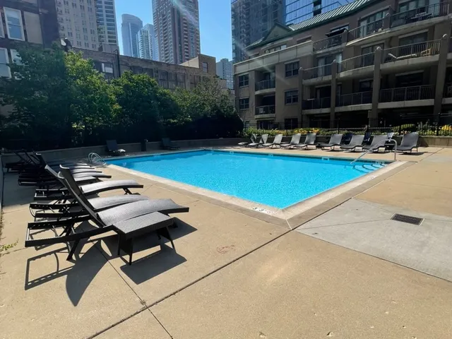 a swimming pool with outdoor seating and yard