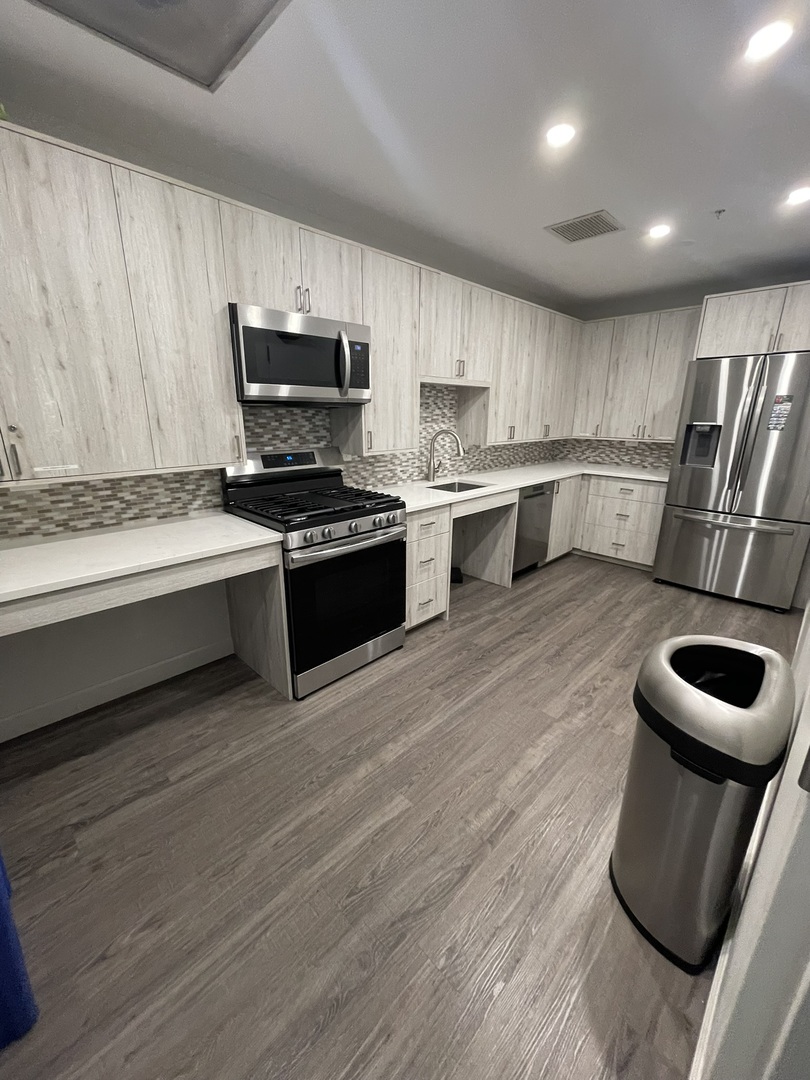 1101 South State Street, Unit 2104 Chicago, IL 60605 - Photo 36 of 37 a kitchen with stainless steel appliances granite countertop a stove a sink and a refrigerator