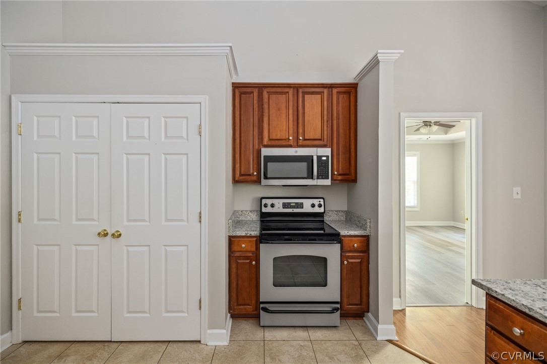 1305 Eastham Road Bumpass, VA 23024 - Photo 20 of 49 Kitchen featuring crown molding, light stone count