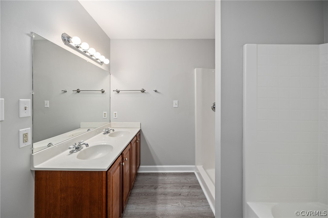 1305 Eastham Road Bumpass, VA 23024 - Photo 29 of 49 Bathroom with wood-type flooring and double sink v