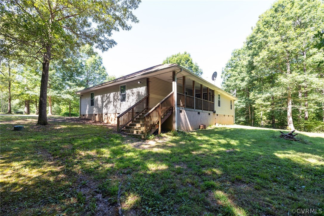 1305 Eastham Road Bumpass, VA 23024 - Photo 40 of 49 Rear view of house featuring a yard