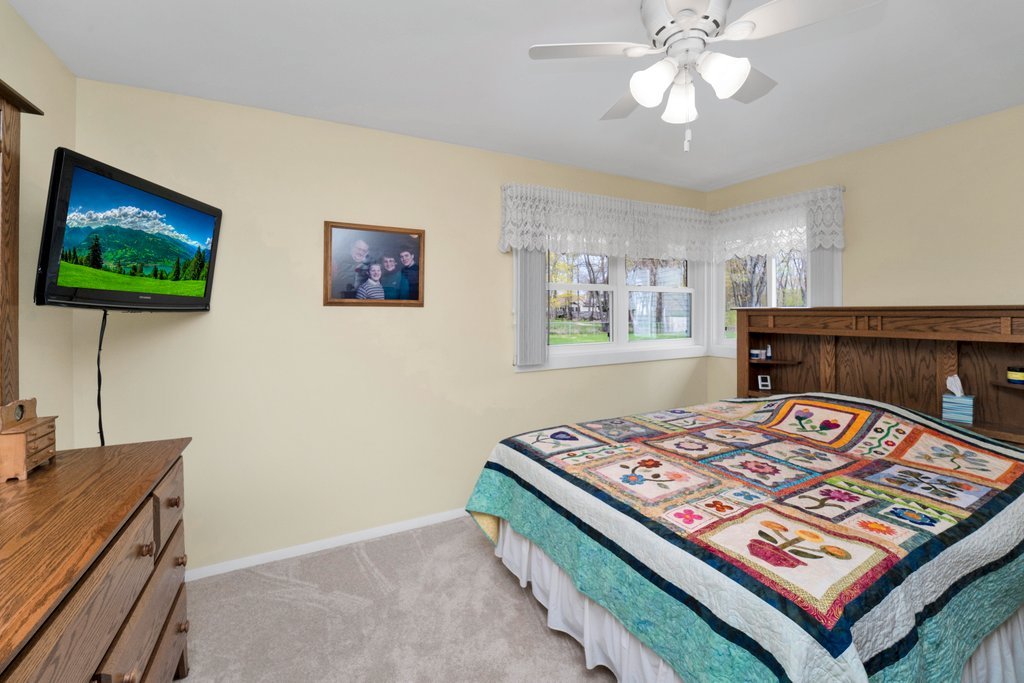 16 Tweed Road Fox Lake, IL 60020 - Photo 13 of 27 a living room with a bed and a flat screen tv