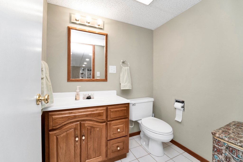 16 Tweed Road Fox Lake, IL 60020 - Photo 17 of 27 a bathroom with a sink a toilet and mirror