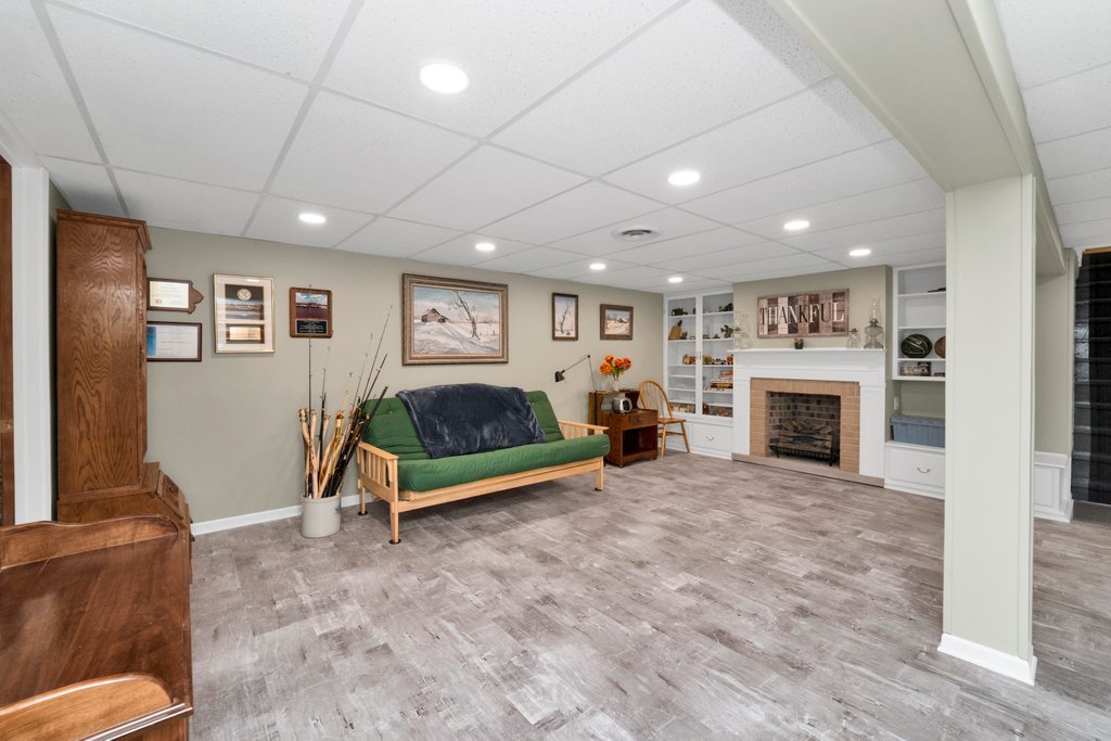 16 Tweed Road Fox Lake, IL 60020 - Photo 20 of 27 a living room with furniture a fireplace and a table