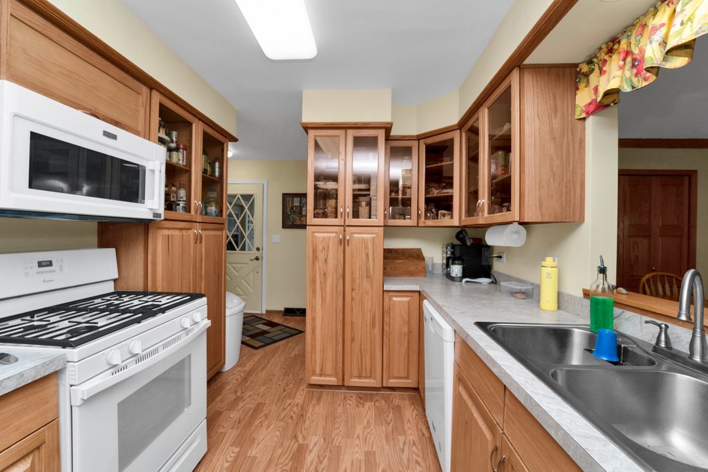 16 Tweed Road Fox Lake, IL 60020 - Photo 10 of 27 a kitchen with stainless steel appliances granite countertop a stove and a sink