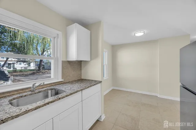 a kitchen with granite countertop a sink and a granite counter top