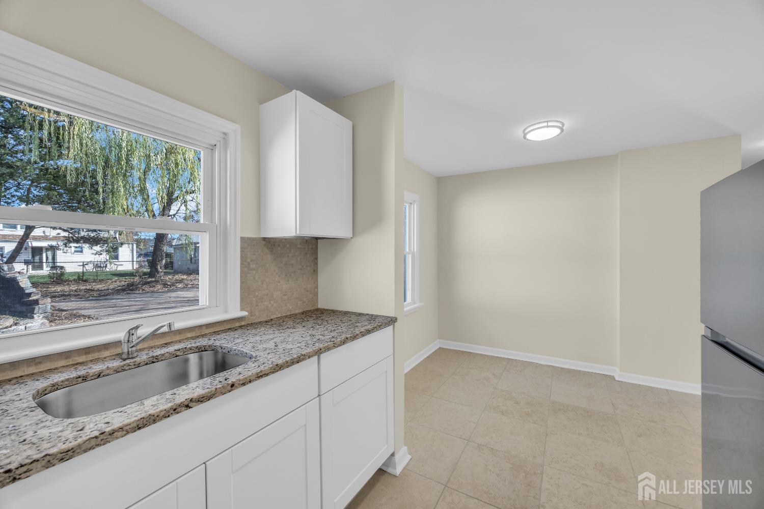 11 North Randolphville Road Piscataway, NJ 08854 - Photo 12 of 28 a kitchen with granite countertop a sink and a granite counter top