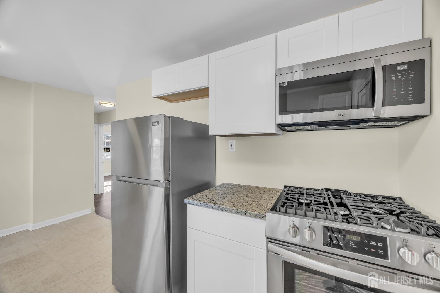 11 North Randolphville Road Piscataway, NJ 08854 - Photo 13 of 28 a kitchen with stainless steel appliances white cabinets and stove