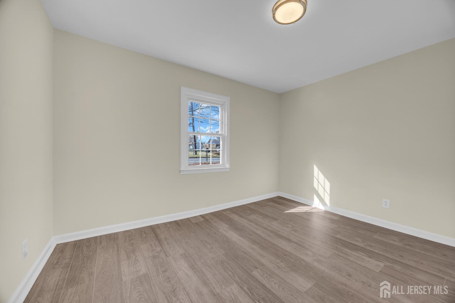 11 North Randolphville Road Piscataway, NJ 08854 - Photo 15 of 28 a view of an empty room with wooden floor and a window