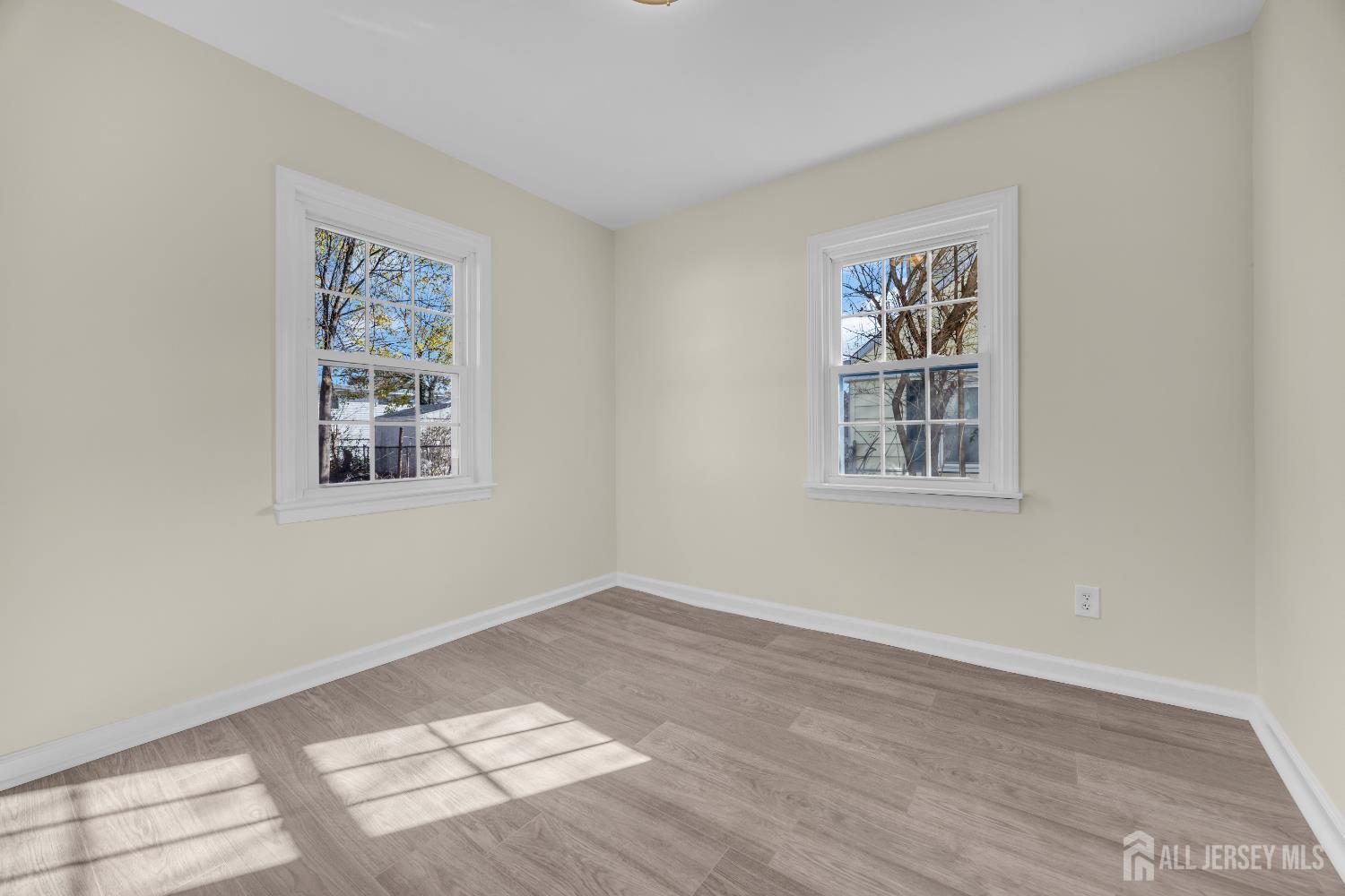 11 North Randolphville Road Piscataway, NJ 08854 - Photo 16 of 28 a view of an empty room with a window and wooden floor