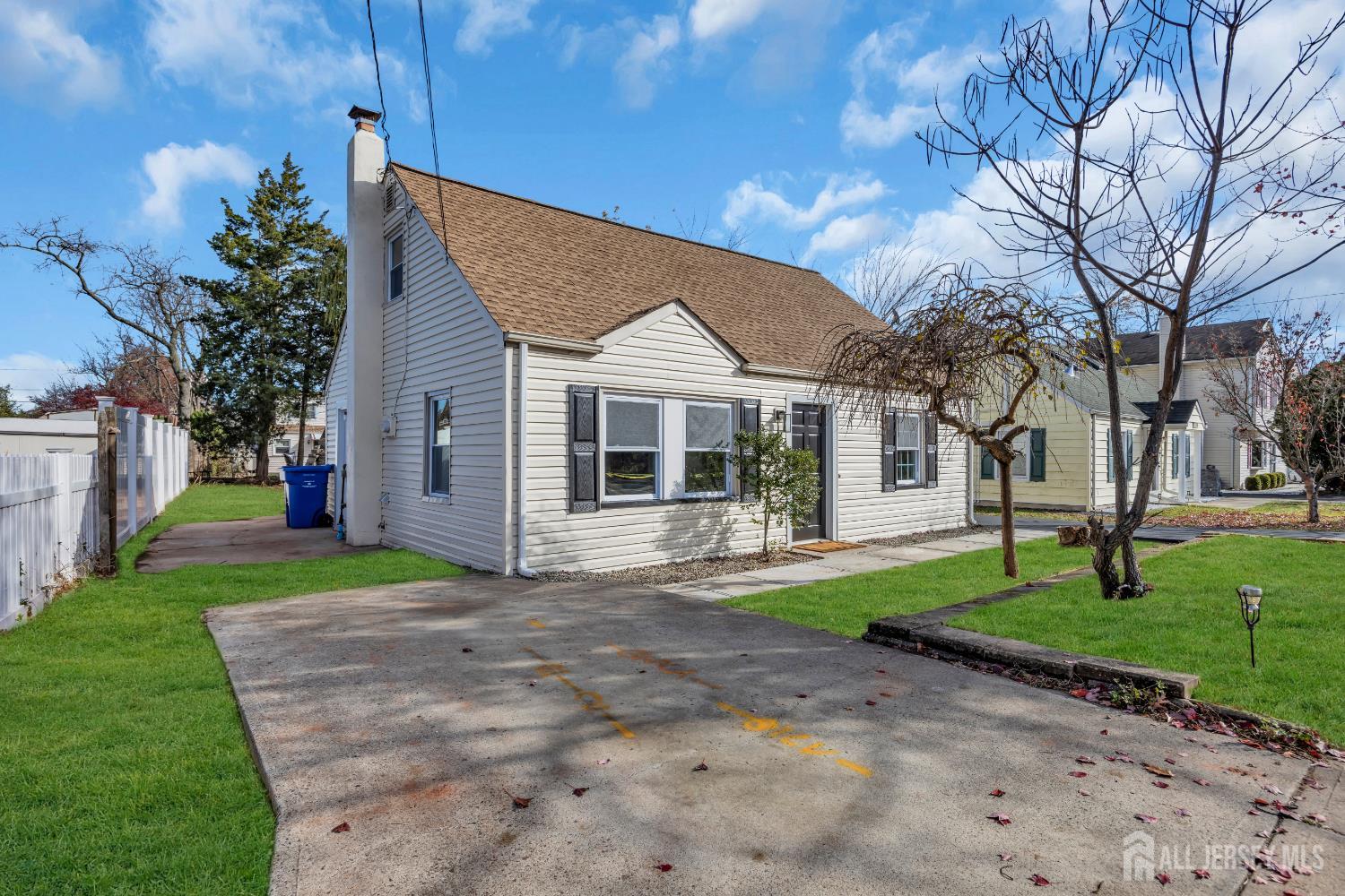 11 North Randolphville Road Piscataway, NJ 08854 - Photo 3 of 28 a front view of a house with a garden and trees