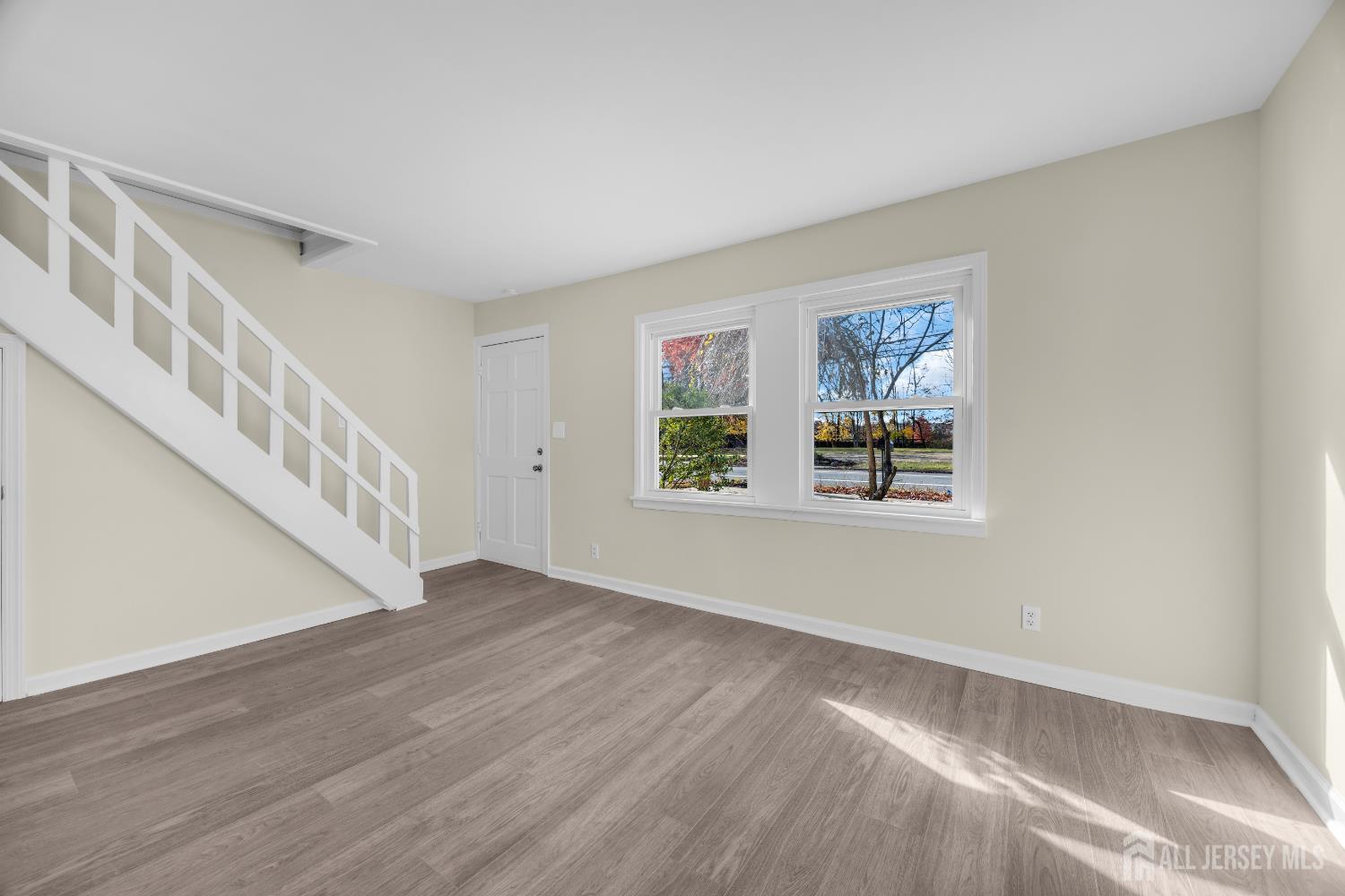 11 North Randolphville Road Piscataway, NJ 08854 - Photo 4 of 28 a view of an empty room with wooden floor and a window