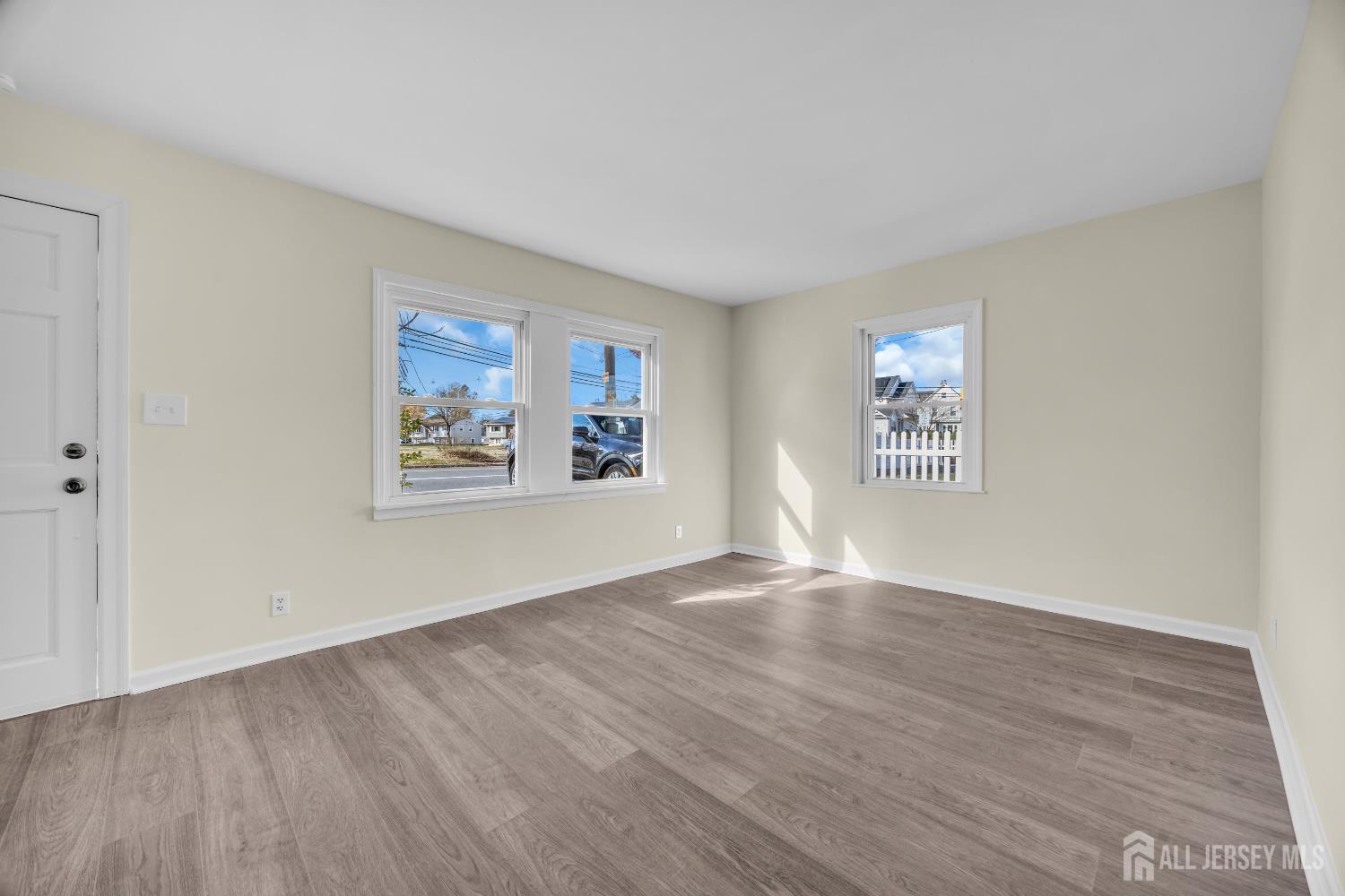 11 North Randolphville Road Piscataway, NJ 08854 - Photo 5 of 28 a view of an empty room with wooden floor and a window