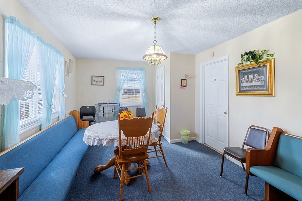 2219 Jenkins Road Chattanooga, TN 37421 - Photo 17 of 29 a dining room with furniture a chandelier and wooden floor