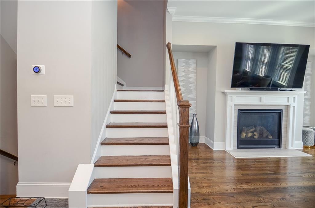 2143 Shale Lane Northwest Atlanta, GA 30318 - Photo 18 of 48 a living room with a fireplace and a flat screen tv
