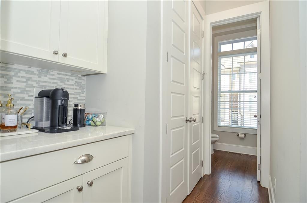2143 Shale Lane Northwest Atlanta, GA 30318 - Photo 19 of 48 a hallway with white cabinets and wooden floor