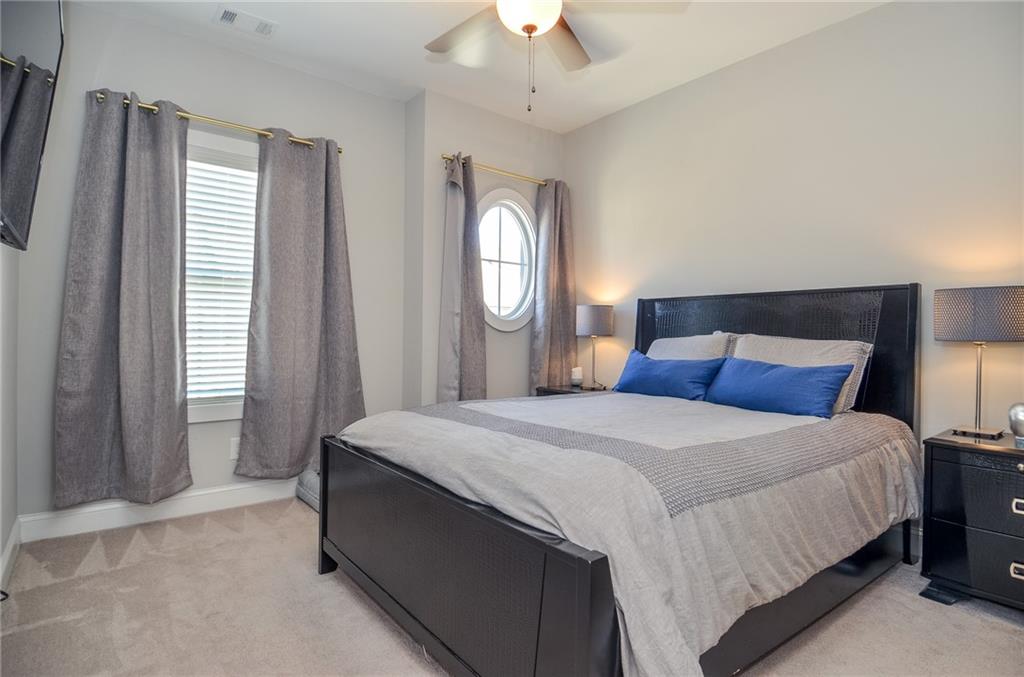 2143 Shale Lane Northwest Atlanta, GA 30318 - Photo 25 of 48 a bedroom with a bed and a chandelier