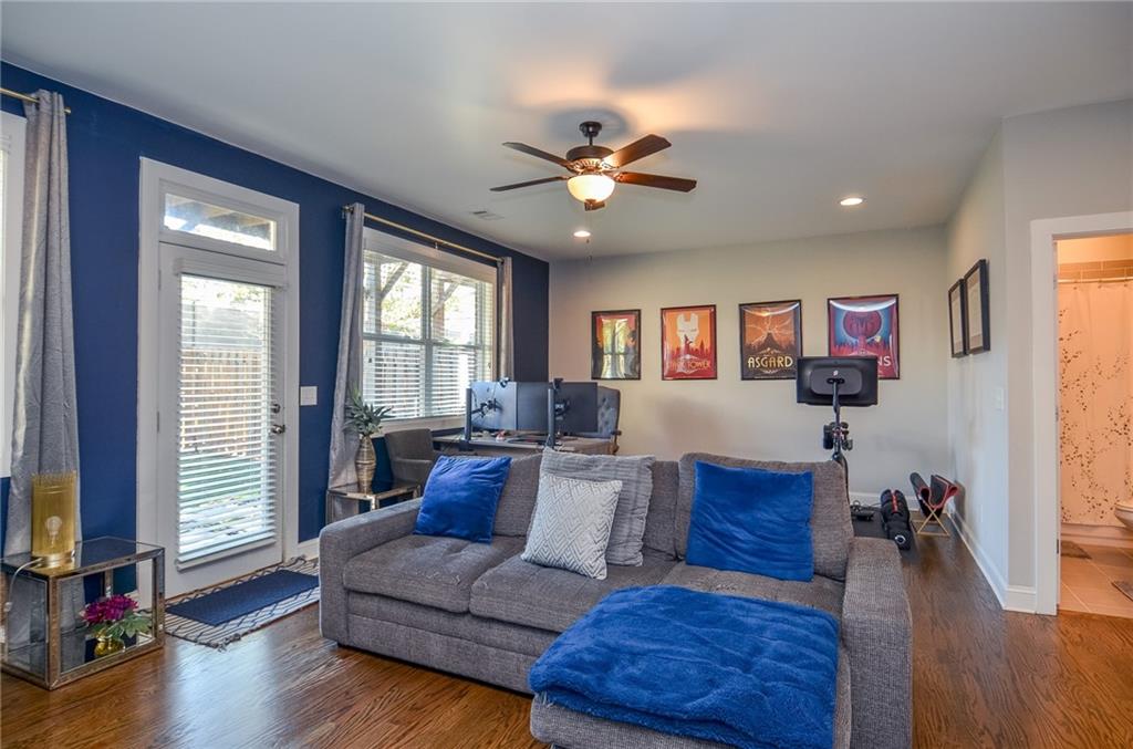 2143 Shale Lane Northwest Atlanta, GA 30318 - Photo 32 of 48 a living room with furniture and a flat screen tv with wooden floor