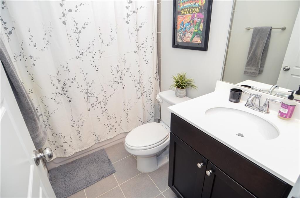2143 Shale Lane Northwest Atlanta, GA 30318 - Photo 35 of 48 a bathroom with a sink toilet and a mirror