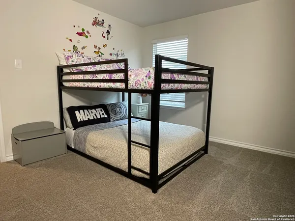 a bedroom with two beds and a window