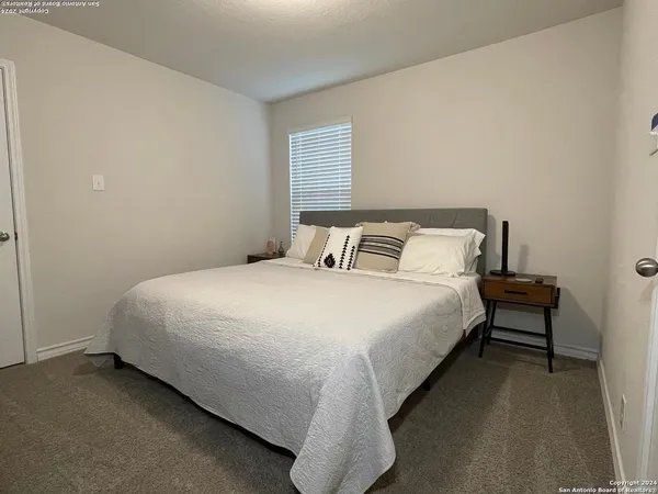 a bedroom with a bed and window