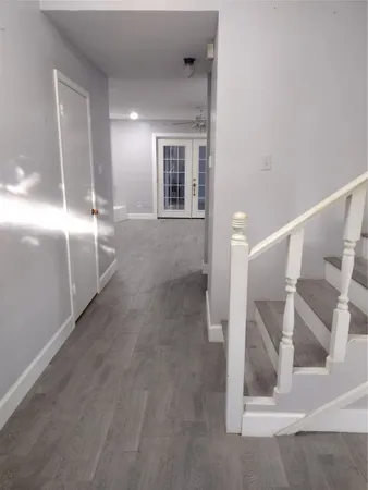 a view of entryway and hall with wooden floor