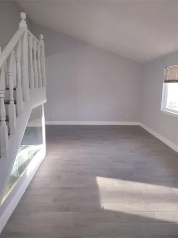 a view of staircase with white walls and window