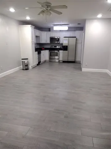 a view of kitchen with cabinets and window