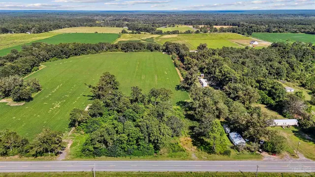 an aerial view of a golf course with a swimming pool