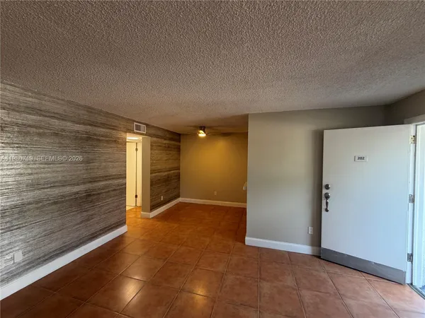 a view of an empty room and fire place