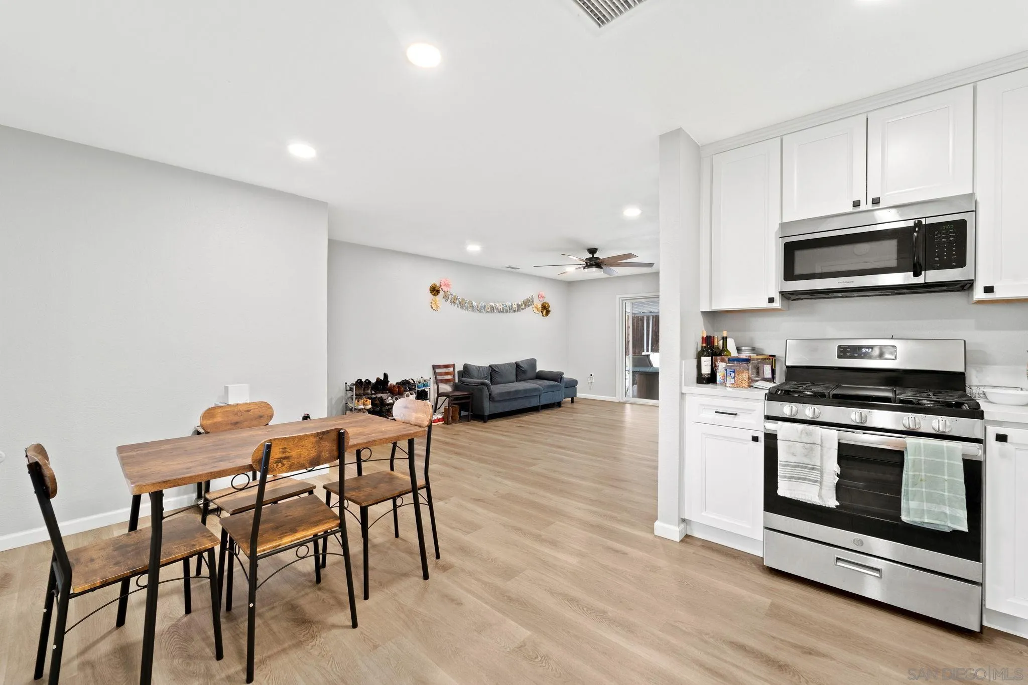 a kitchen with stainless steel appliances a stove a sink a microwave and a refrigerator