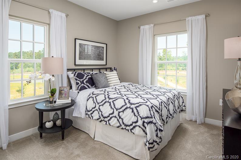 910 Portrush Lane, Unit 1015B Tega Cay, SC 29708 - Photo 6 of 8 a bedroom with a bed and a window
